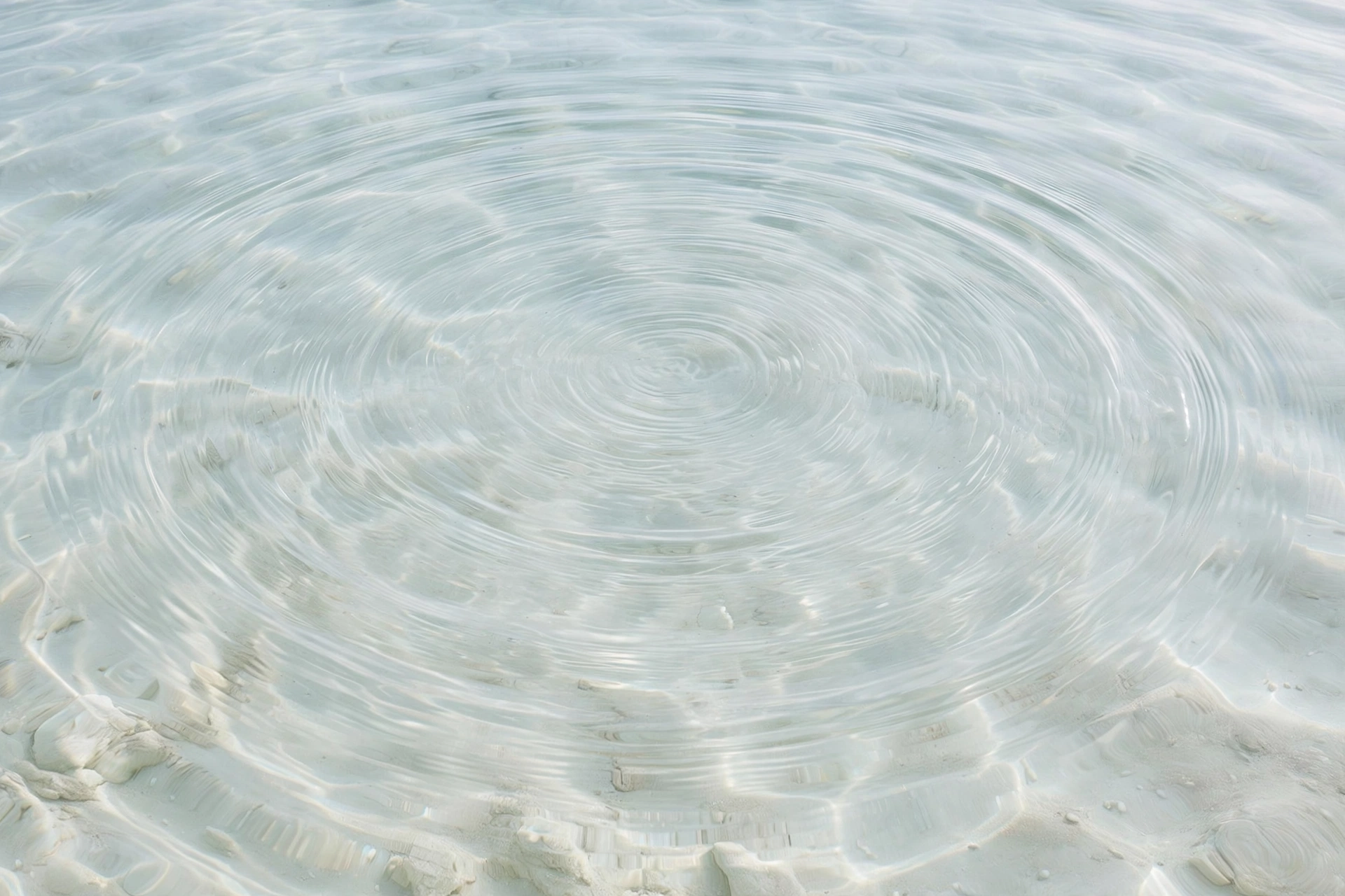 Calm, crystal-clear salt-water pool surface with soft ripples